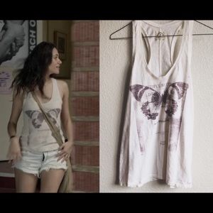 AEO Butterfly 
As seen on shameless. cream color with a pastel purpleLoose fit.